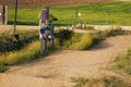 Side view of man performing stunt with motorcycle on motocross track Royalty Free Stock Photo