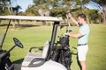 Side view of man putting golf club in bag Royalty Free Stock Photo