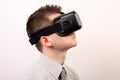 Side view of a man wearing a VR Virtual reality Oculus Rift 3D headset, profile looking right slightly upwards