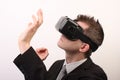 Side view of a man wearing a VR Virtual reality Oculus Rift 3D headset, touching something with his hands, exploring
