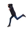 Side view of a man in a winter jacket who jumps