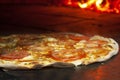 Side view of marguerita pizza on a brick pizza oven. Pizza marguerita on the table. Royalty Free Stock Photo