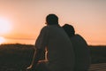 Side view a married couple a silhouette sitting on a bench. Royalty Free Stock Photo