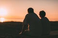 Side view a married couple a silhouette sitting on a bench. Royalty Free Stock Photo