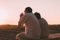 Side view a married couple a silhouette sitting on a bench. Royalty Free Stock Photo