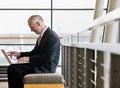 Side view of mature businessman working on laptop