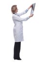 Side view of mature female doctor holding X-ray Royalty Free Stock Photo