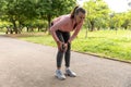 Exhausted jogger woman in the park