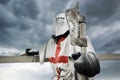 Crusader in armor holding axe.