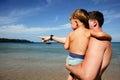 Man with boy exploring seashore