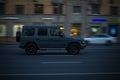 Side view of Mercedes-Benz G Class Gelandewagen drive on high speed. Driving auto at night on city road. Blured car motion in Royalty Free Stock Photo