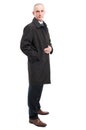 Side view of middle age elegant man posing wearing raincoat Royalty Free Stock Photo