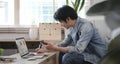 Side view millennial man searching information online, working with computer laptop in living room Royalty Free Stock Photo