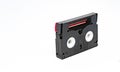 Side view of a Mini DV format video cassette isolated on a white background Royalty Free Stock Photo