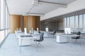 Side view on minimalistic style workspace white tables with modern computers on concrete floor in open space office with wooden Royalty Free Stock Photo