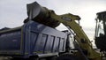 Side view of a mining truck with its bucket loaded with sand. Scene. Heavy industry and machinery concept, industrial Royalty Free Stock Photo