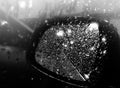 Side view mirror of motor vehicle covered in raindrops. Rain, mist. Poor visible Royalty Free Stock Photo