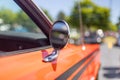 Side view mirror of orange vintage car close up view , Shallow depth of field Royalty Free Stock Photo