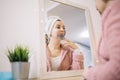 Side view of mirror reflection of a woman with face mask Royalty Free Stock Photo