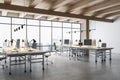 Side view on modern eco style spacious coworking office with wooden ceiling and workspaces, modern computers, concrete floor and Royalty Free Stock Photo