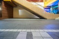 Side view of modern escalator and empty tiled floor at night Royalty Free Stock Photo