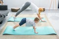 Side view of mother and little son in adho mukha svanasana position