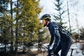 Side view of mountain biker riding in snow outdoors in winter nature. Royalty Free Stock Photo