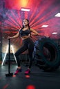 Female bodybuilder posing with sledgehammer. Royalty Free Stock Photo