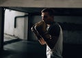 Side view of muscular young man boxing with punching bag Royalty Free Stock Photo
