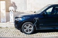 Side view of new luxury BMW suv car being charged with electricity near power Royalty Free Stock Photo