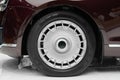 Side view on new luxury car wheel on silver metal rim with black shine tire. Modern classic car wheel Royalty Free Stock Photo