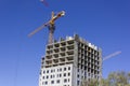 A new unfinished building with a construction crane