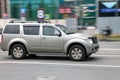 Side view of Nissan Pathfinder R51 suv in motion. Gray 4x4 car moving on the street Royalty Free Stock Photo