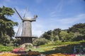 Side view of the North (Dutch) windmill with beautiful flowers and trees in Golden Gate Park, USA Royalty Free Stock Photo