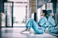 Side view of nurse sitting on floor Royalty Free Stock Photo