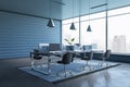 Side view on office with modern computers on work table with dark chairs on light carpet on concrete glossy floor on blue slatted Royalty Free Stock Photo