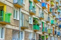 Side view of old apartment house facade with colorful balconies Royalty Free Stock Photo