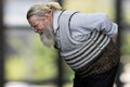 Side view of old bearded man suffering from back pain. Royalty Free Stock Photo