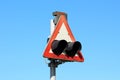 Side view of old rectangle red and white railway crossing warning lights sign mounted on strong metal pole Royalty Free Stock Photo