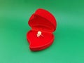 A side view of an old sparkling white pearl ring in a red ring box Royalty Free Stock Photo