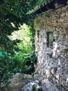 Side view of old stone country house and overgrown garden Royalty Free Stock Photo