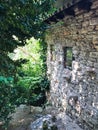 Side view of old stone country house and overgrown garden Royalty Free Stock Photo