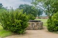 Side view of old stone water well with wooden cover Royalty Free Stock Photo