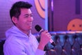 Asian young man holding microphone singing at karaoke Royalty Free Stock Photo