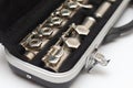 Side view of an open case with a flute lying in it with large keys close-up Royalty Free Stock Photo