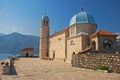 Side view of Our Lady of the Rocks islet off the coast of small old town Perast in Bay of Kotor, Montenegro mountainous background