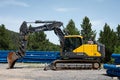 Side view of a parked large yellow and black Volvo EC160E excavator with bucket in construction site