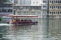 Side view of Passenger transportation with boat, water taxi trip. People wearing life jackets traveling in public ferry boat.