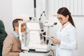 side view of patient getting eye examination in slit lamp Royalty Free Stock Photo