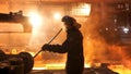 Side view of the perator remove waste from furnace pipe at the iron melting plant. Stock footage. Man worker in heat